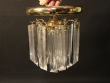a person that is holding a glass chandelier in their hand