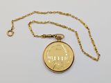 a gold pocket watch with a chain on a white surface