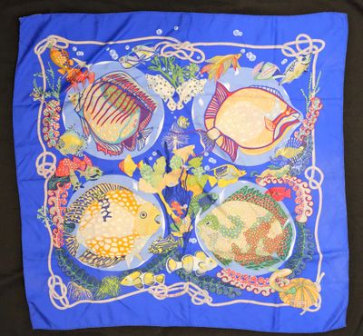an image of a blue scarf with fish and flowers on it
