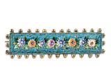 a close up of a blue and yellow beaded bracelet with flowers