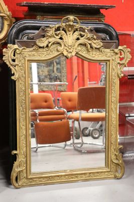 a mirror that is sitting on a table next to a clock