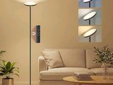 a living room with a couch, table, lamp and pictures on the wall