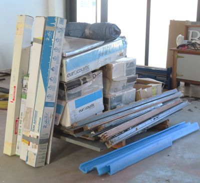 a pile of boxes on a pallet in the middle of a room