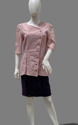 mannequin wearing a pink shirt and black skirt on a white mannequin