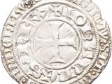 an old silver coin with a cross on it