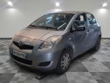 a picture of a silver toyota yaris parked in a showroom