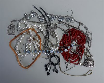 many different types of necklaces and bracelets laid out on a table