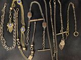 several different types of necklaces and bracelets on a black background