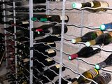 many bottles of wine that are stacked on a rack