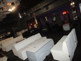 many white couches and tables in a room