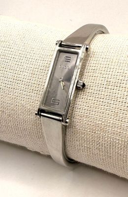 wrist watch on a napkin on a white table cloth
