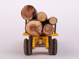 a toy truck with logs on the back of it