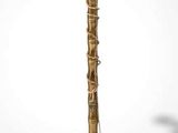 brass plated floor lamp with a glass shade and a metal base