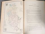 an open book with a map on it on a table