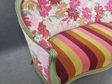 a close up of a chair with a colorful striped cushion on it