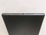 the back of a laptop computer sitting on top of a white table