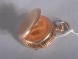 a small gold pocket watch with a chain around it