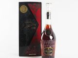 a bottle of brandy in front of a black box