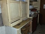 an old refrigerator in the middle of a dirty kitchen