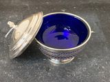 an image of a blue glass bowl with a lid sitting on a table