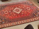 a red rug on the floor in a room