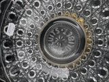 a clock that is sitting on top of a glass plate