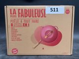 packaging of a pink bowl with a wooden spoon in it on a table