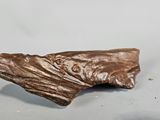 a small piece of chocolate that is on top of a table