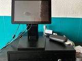 a tablet computer sitting on top of a cash register