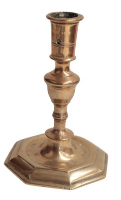 a small metal candle holder on a white background