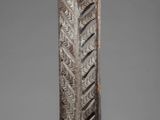 a close up of a metal object on a gray surface