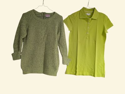 two women ' s shirts hanging on a hanger on a white wall