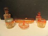 many different colored glass items sitting on a table