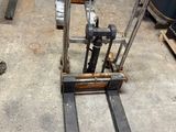 a fork lifter that is sitting in a garage