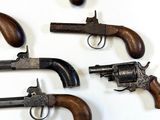 many different types of guns on display on a table