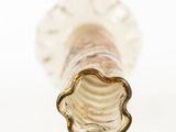 a close up view of a glass vase with a gold rim