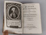 an open book with a picture of a man in a suit on it