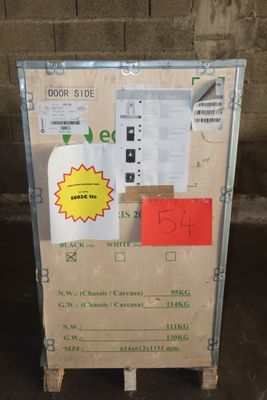 a cardboard box with a sign on it sitting in front of a brick wall