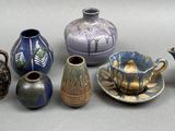 many different types of vases sitting on a table