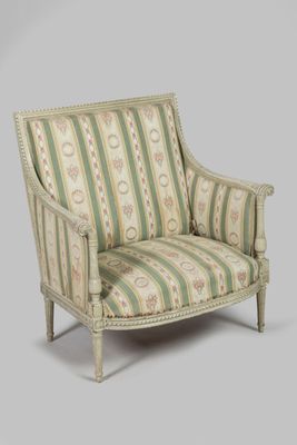 an upholstered chair with a striped upholstered back and arms