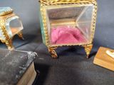 a small glass box with a pink bed inside of it