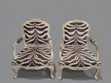 pair of zebra print chairs on a grey background