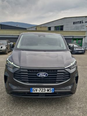 the front view of a grey suv parked in front of a building