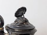 a silver coffee pot sitting on top of a table