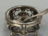 a silver bowl with a spoon in it and a spoon in the bowl