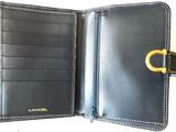leather wallet with a gold ring on the front