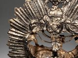 an image of a silver crown with a bird on top of it