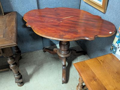a small table with a wooden top in a room
