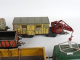 many toy trains and trucks that are on the table