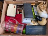 a box full of items that include a cell phone, a water bottle, and other items